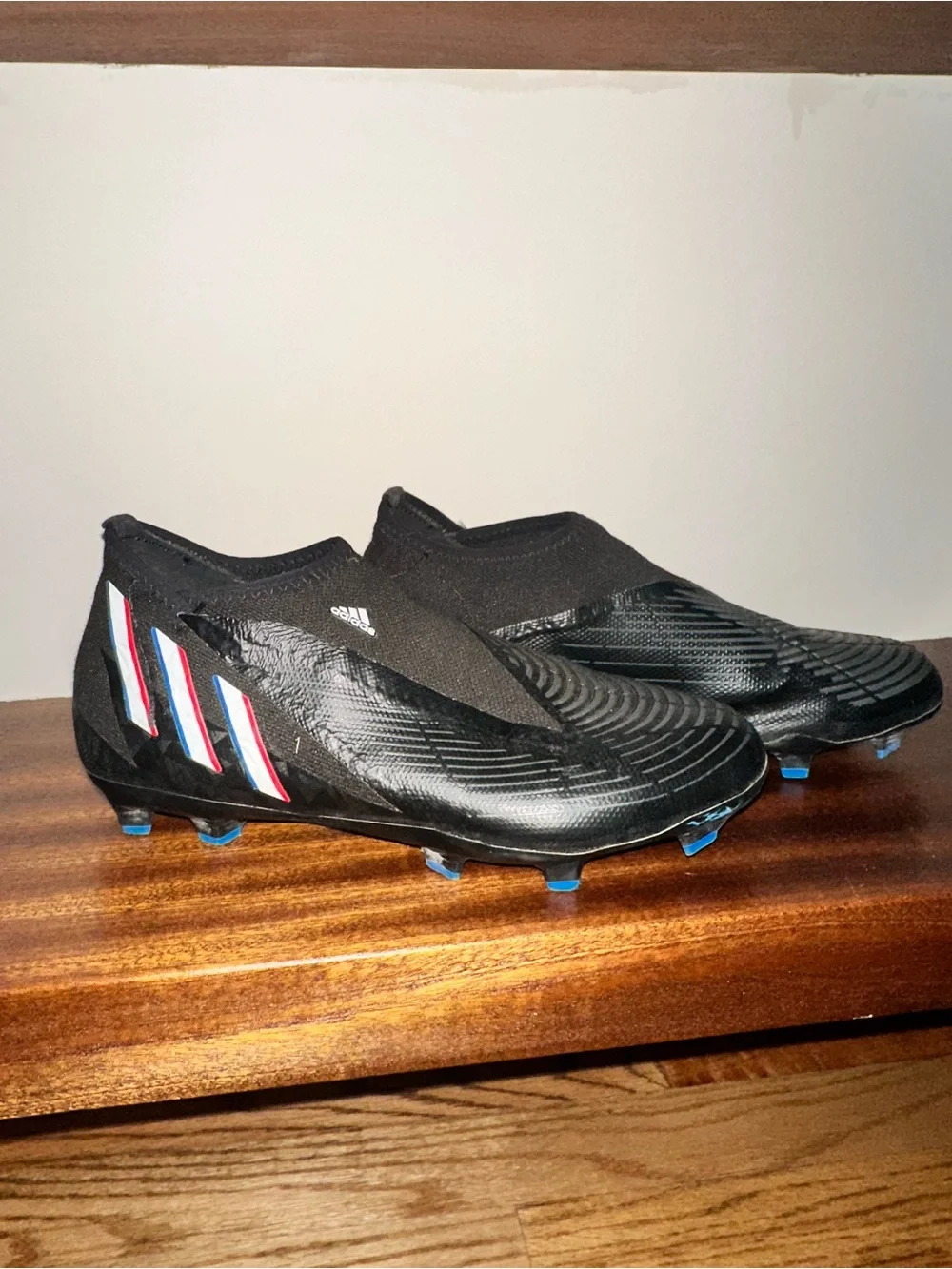 adidas Black Soccer Cleat with Blue and Red Stripe Accents